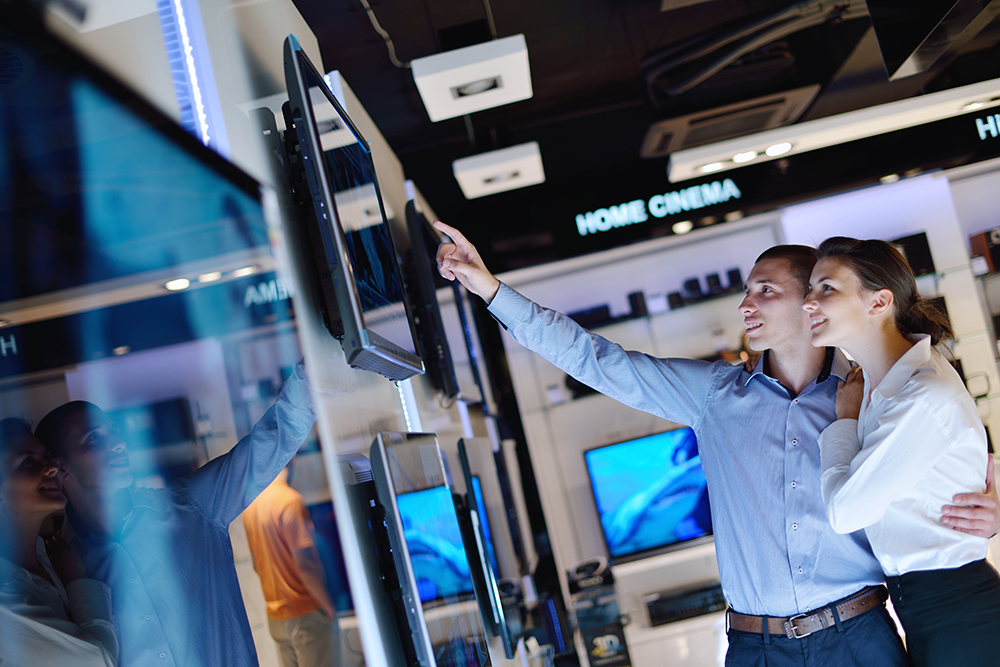 Young couple in consumer electronics store