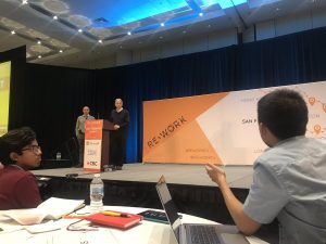 mon on stage at conference event