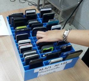 several mobile phones in slotted box