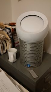 personal air purifer sits on top of office cabinet