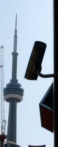 CN Tower in bacground, CCTV camera in silhouette in foreground