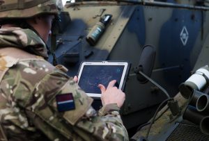 military serviceman holds laptop
