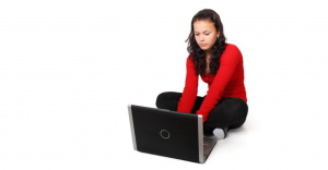woman sitting cross-legged at laptop computer