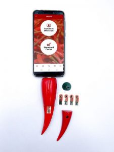 smartphone with pepper-shaped gadget plugged in