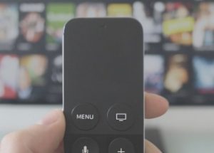 hand holds TV remote control