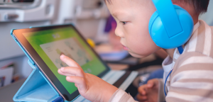 youngster with headphones and tablet