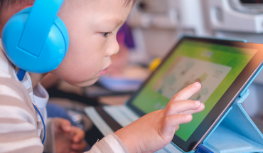 youngster with headphones and tablet