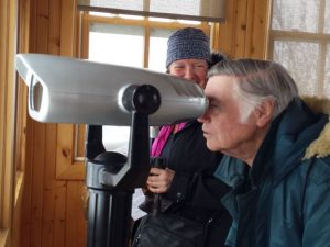 man looks through viewing machine