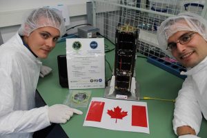 students with Canadian flag work on CubeSats