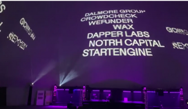 company names projected on giant screen