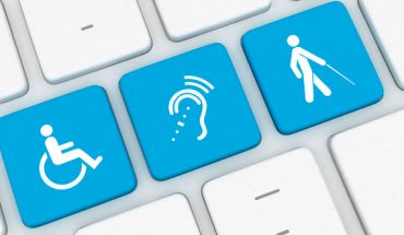 assistive technolgy icons on a computer keyboard include wheelchair, hearing and walking/mobility categories.