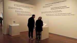 people look at text on wall and museum exhibition