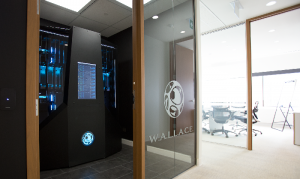 computers and technology seen behind glass doors with Wallace name visible
