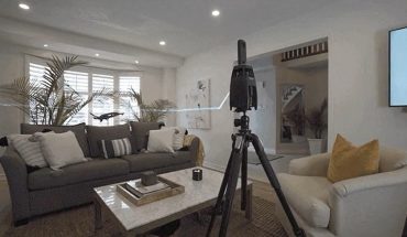 3-D camera device mounted on tripod in residential living room