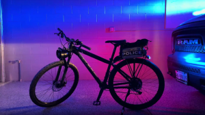 police bike with coloured lighting behind