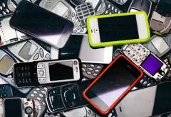 multiple cellphones and smartphones in a pile