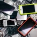 multiple cellphones and smartphones in a pile