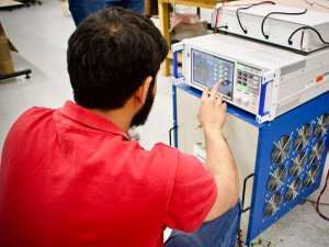 student works at electrical monitoring and measurement device