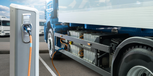 large truck hooked up to electric vehicle charging station