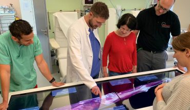 students and faculty gather around Anatomage Table