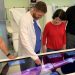 students and faculty gather around Anatomage Table