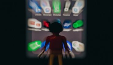 human figure surrounded by blurry social media icons and logos