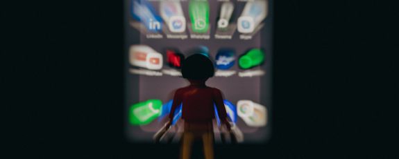 human figure surrounded by blurry social media icons and logos