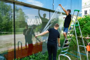 installation crew applies film to windows