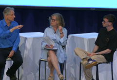 three people seated on stools on a stage; Hinton at left, Frosst at right, Young in the middle