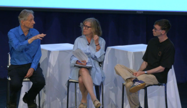three people seated on stools on a stage; Hinton at left, Frosst at right, Young in the middle