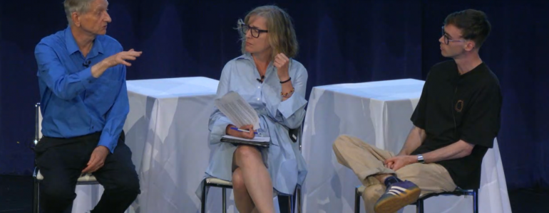 three people seated on stools on a stage; Hinton at left, Frosst at right, Young in the middle