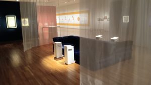 museum seating area with audio listening stations