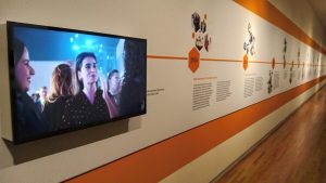 video screen and wall text in museum display