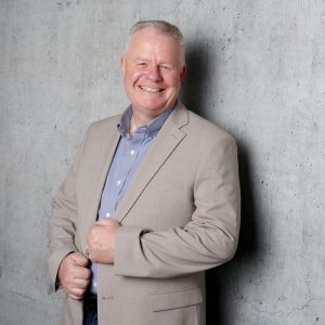 man smiles at camera