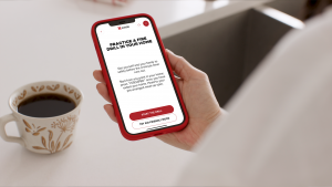 fire safety awareness app on smartphone held by human hand