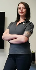 woman with crossed arms looks at camera