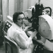 photo of woman in lab coat seated in laboratory