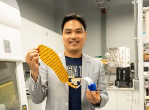 man holds electronic shoe insert